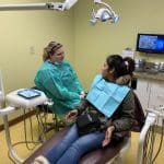 Professional portrait of a dentist, representing Dr. Esther Ghebremichael and Dr. Li of Star Dental Clinic